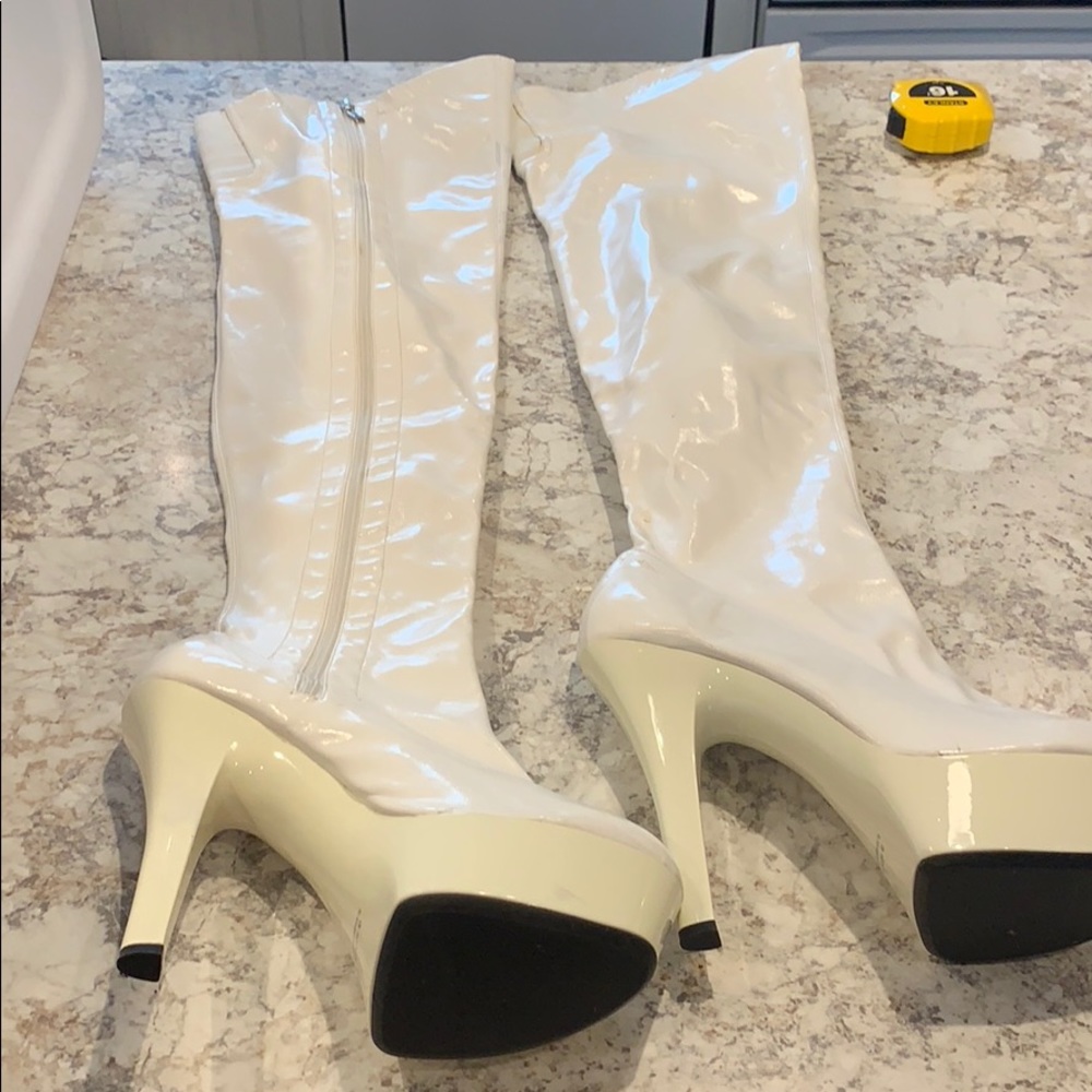 Shiny white thigh high boots